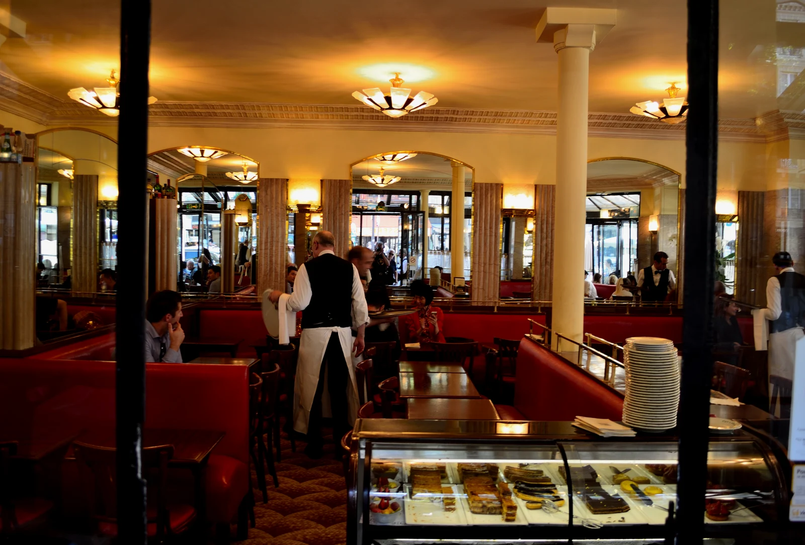 Outdoor French cafe dining with tables set along a sidewalk