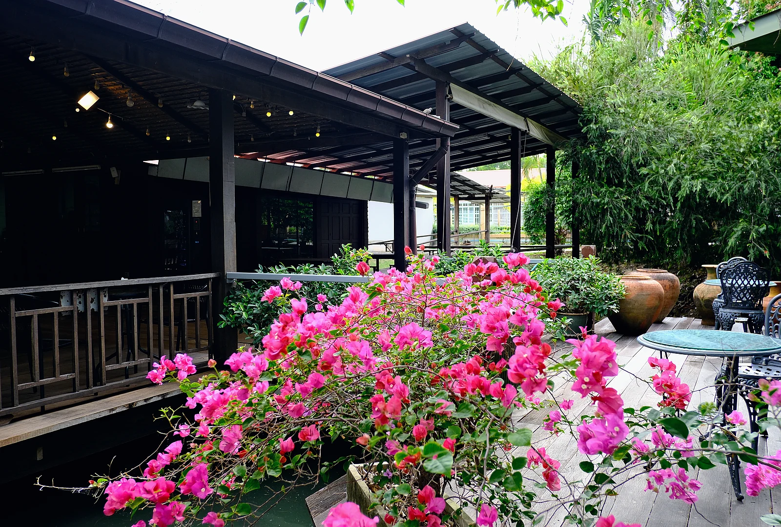 Shaded outdoor restaurant patio with bistro seating