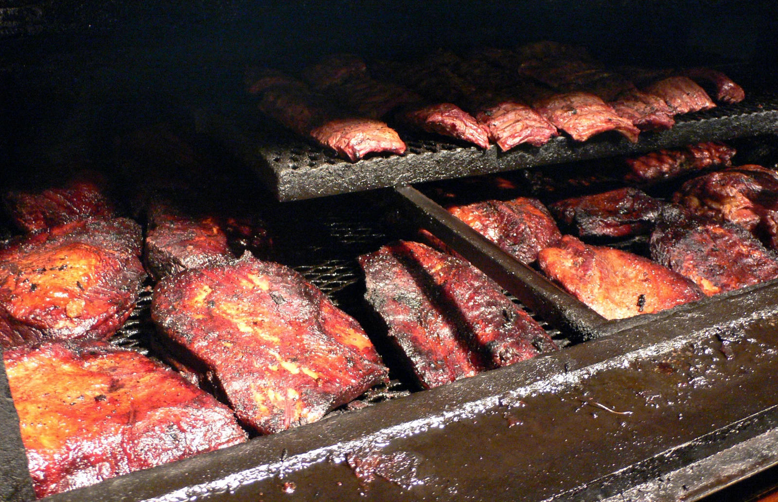 Briskets and ribs stacked at a classic Texas BBQ joint
