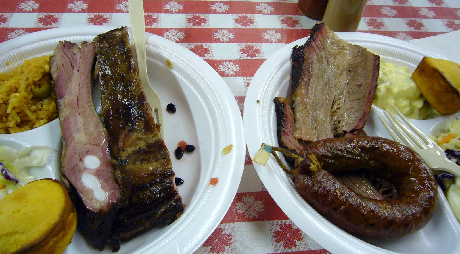 Trays of brisket, sausage, and sides at a Texas BBQ market